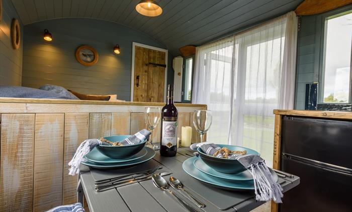 Cosy dining in Susanna - Brook Cottage Shepherd Huts